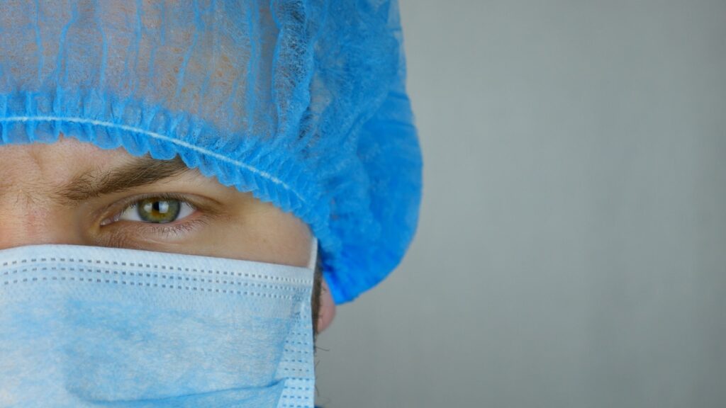 person in white face mask