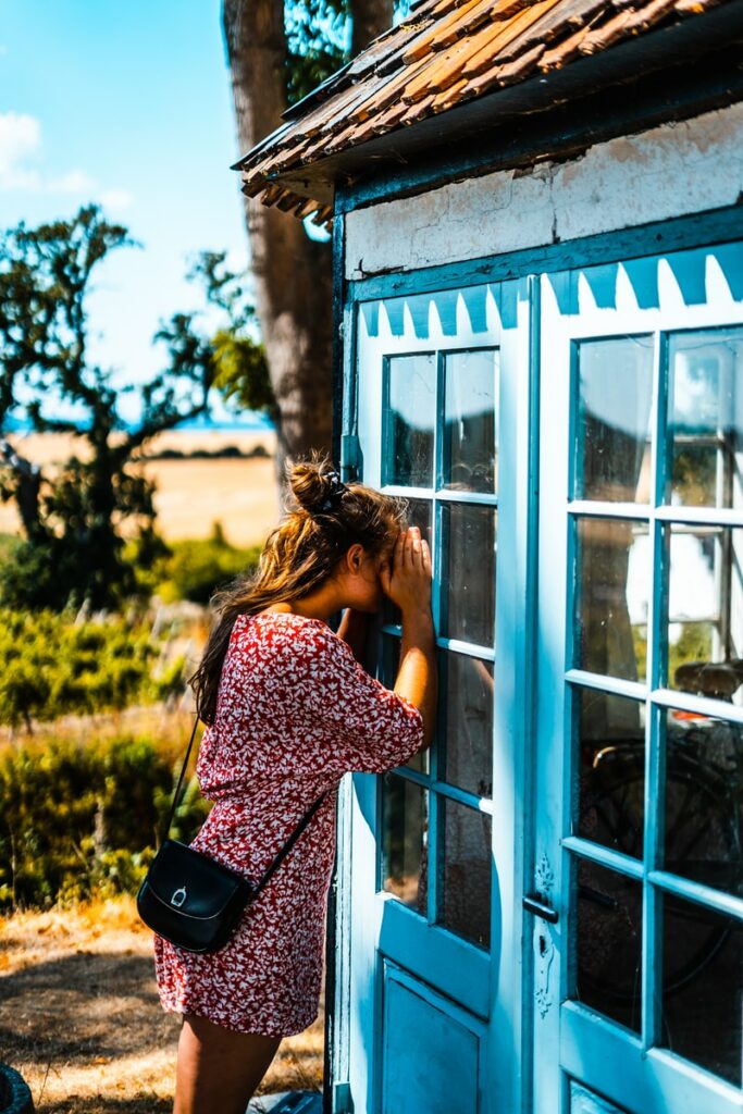 woman peeking on glass door