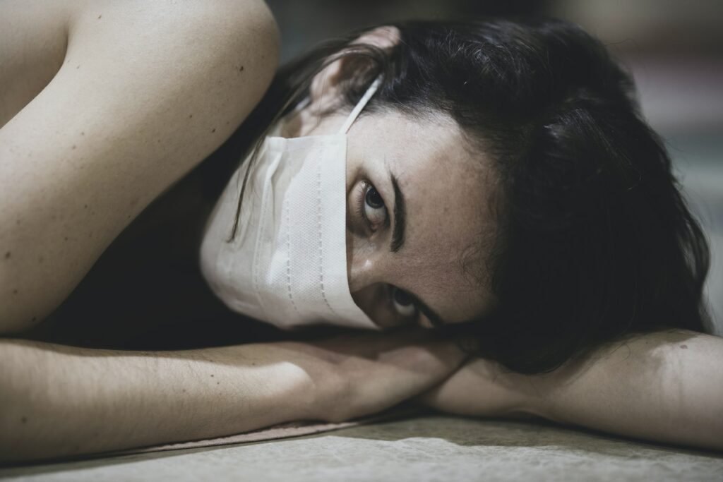 woman lying on white textile