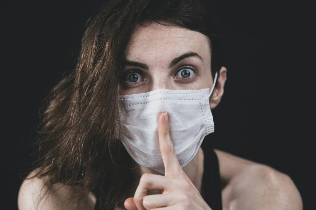 woman in black tank top with white face mask