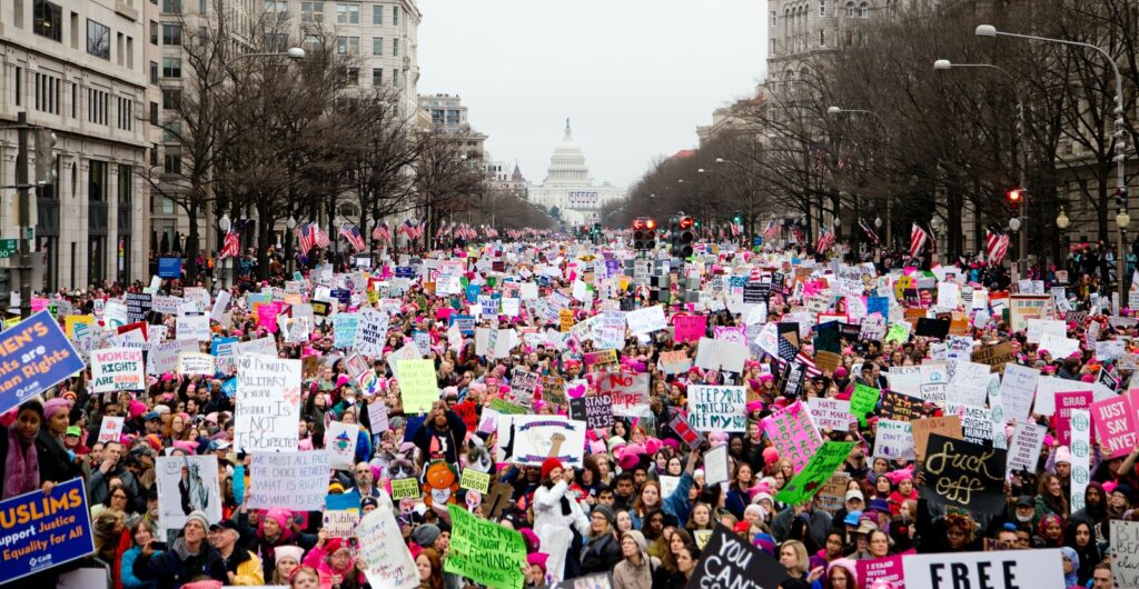 crowd of people holding placards