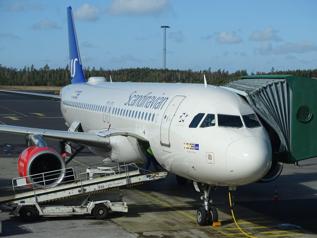 truck parked near commercial airplane on airport