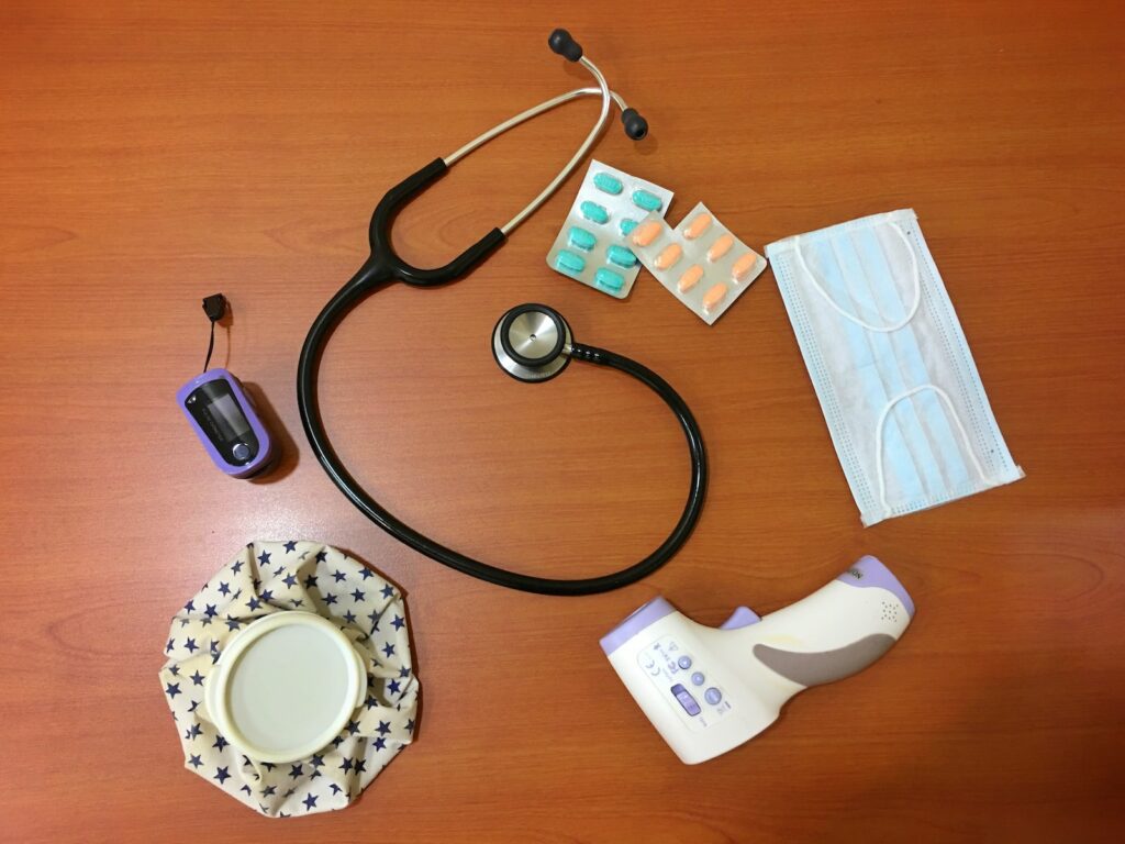 black and silver stethoscope on brown wooden table