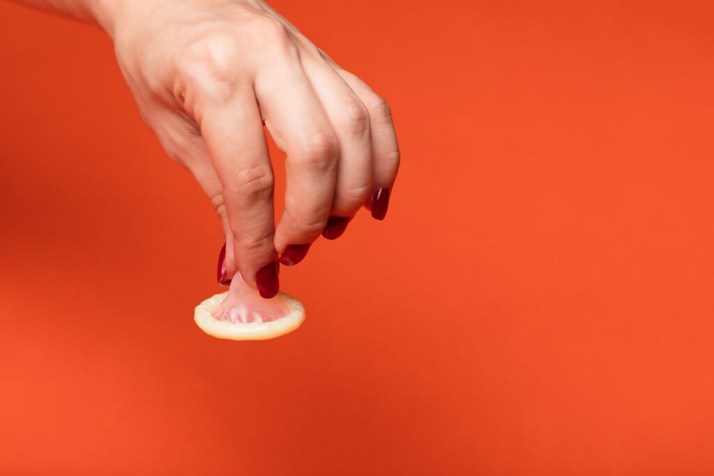 person holding white ceramic heart shaped ornament