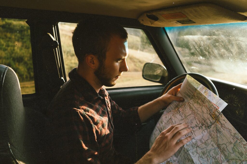 man riding on vehicle looking for map