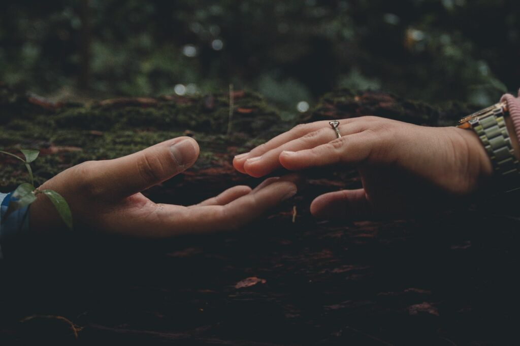 persons hand on brown soil