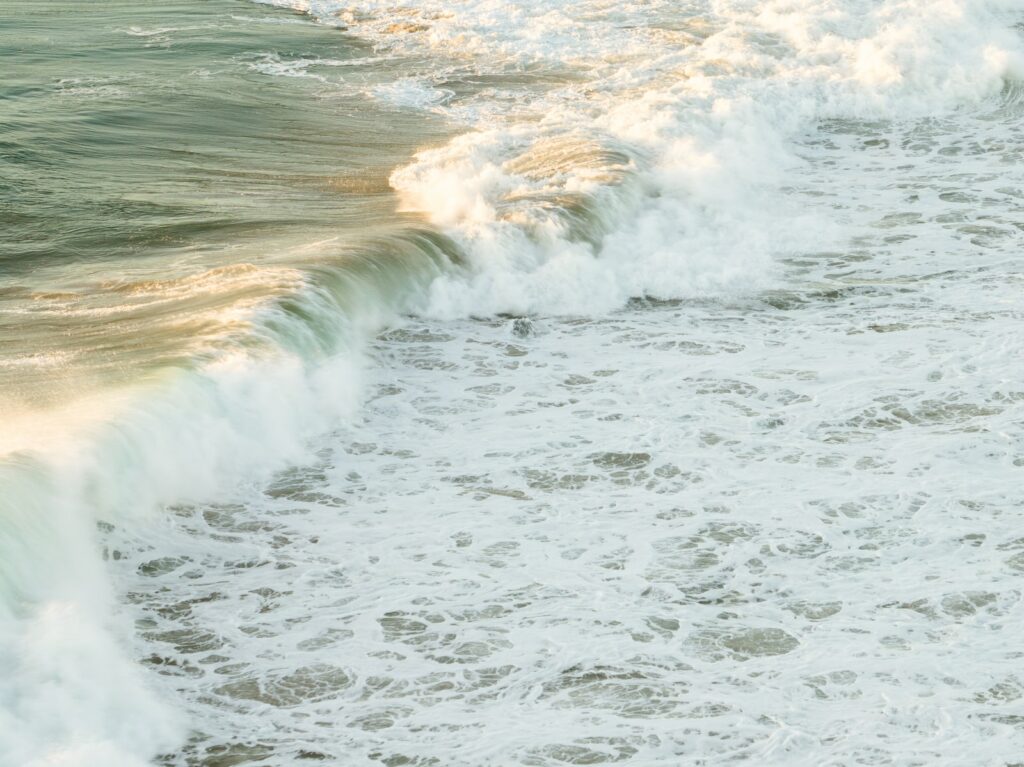 a person riding a surfboard on top of a wave