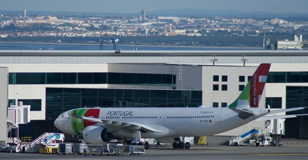 white and red air plane on airport during daytime