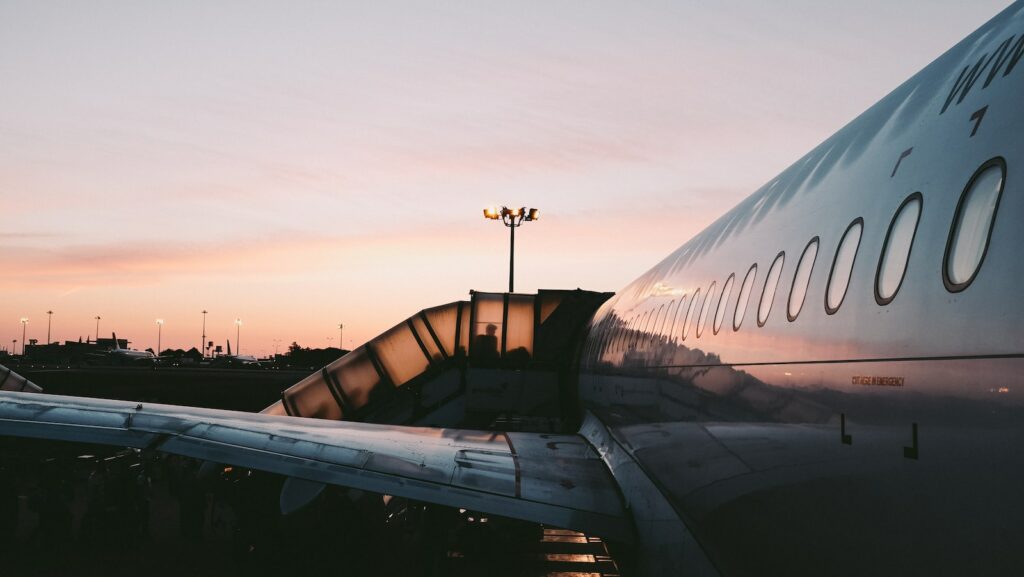 Airplane under gray sky during golden hour