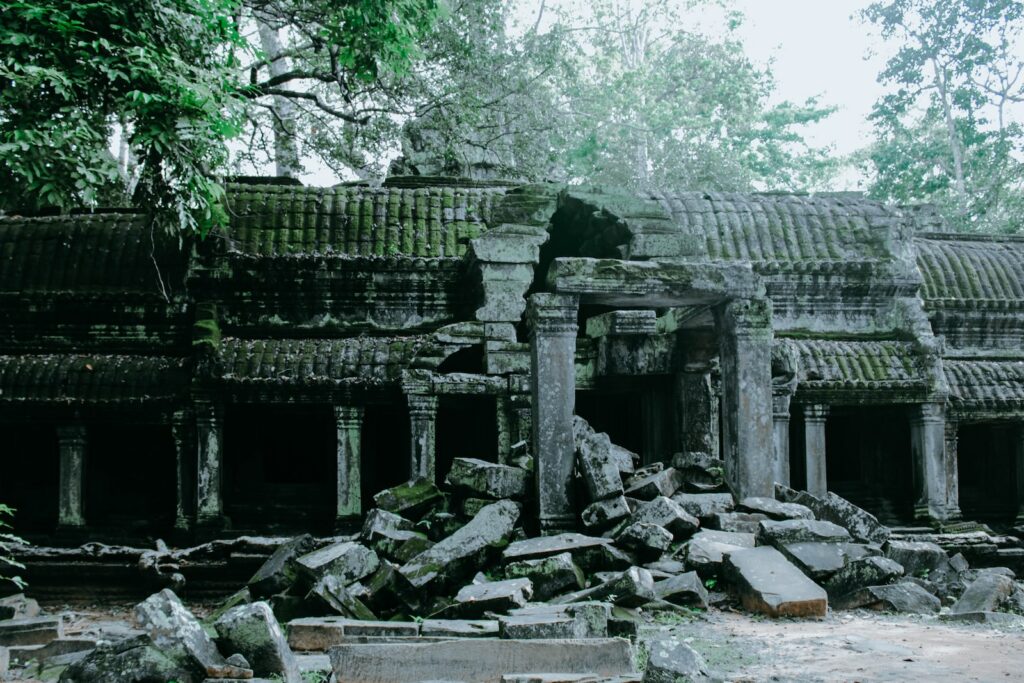 grey concrete ruins near green trees at daytime