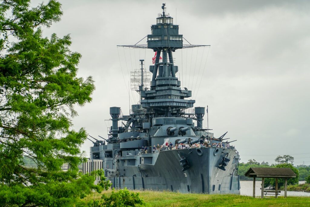 gray and black ship on sea under white clouds during daytime