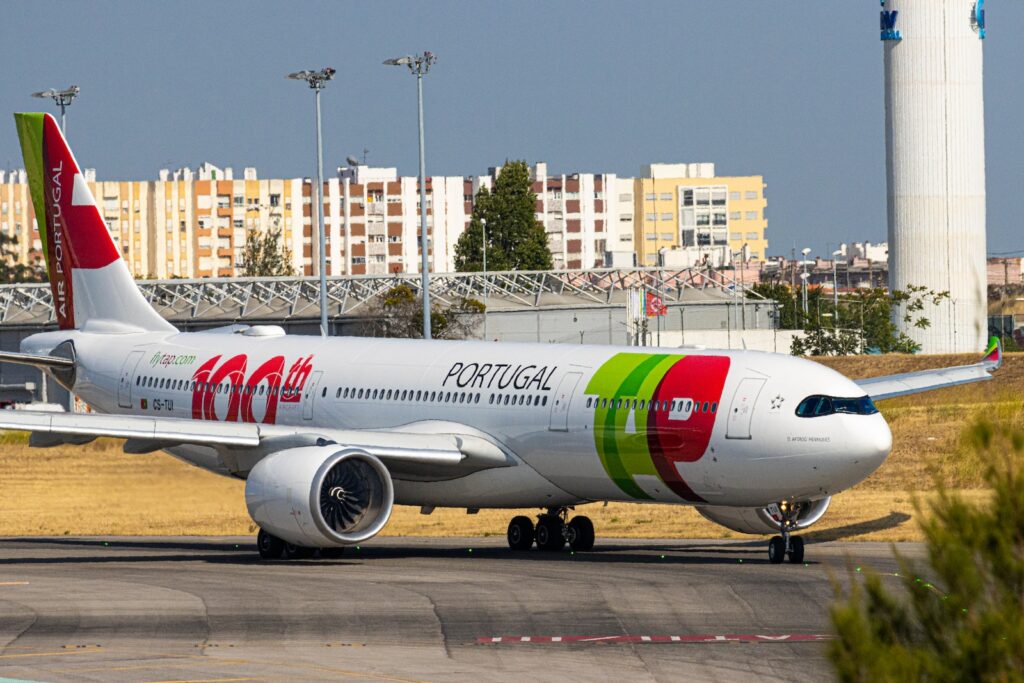 white and red passenger plane on airport during daytime