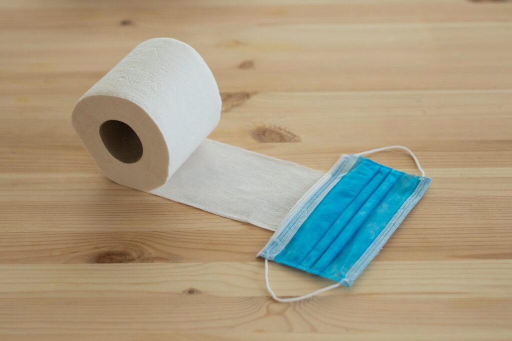 white toilet paper roll on brown wooden table