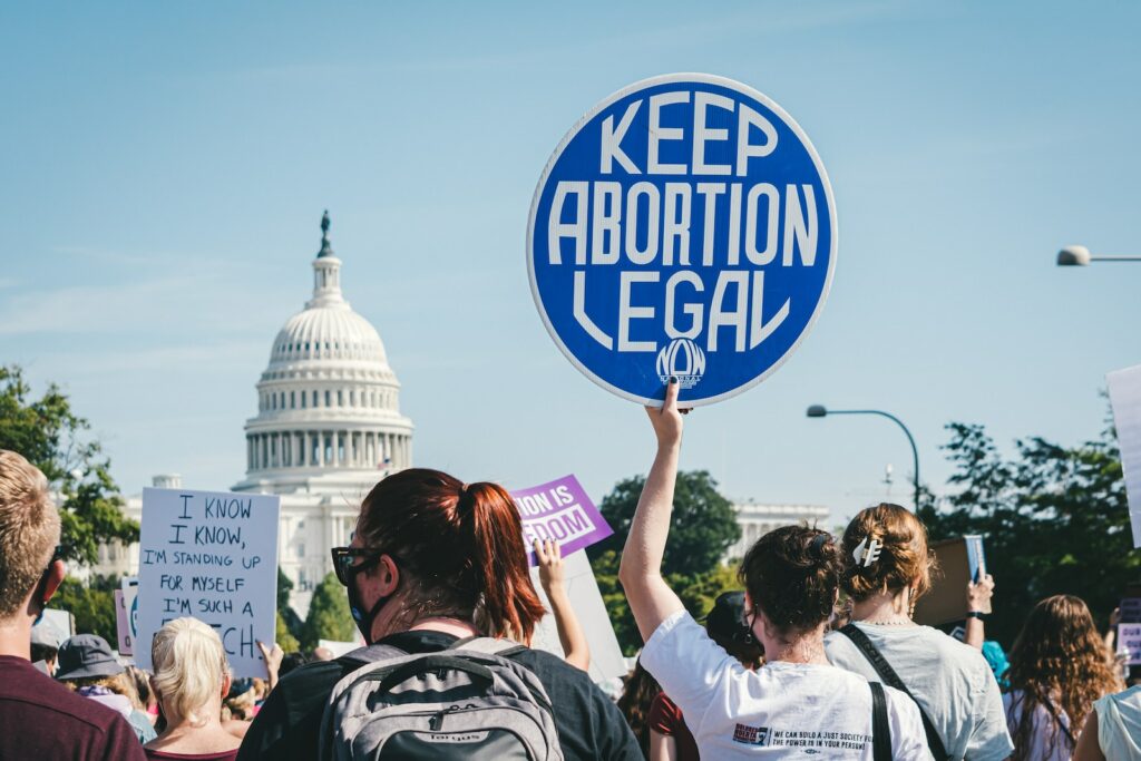 a group of people holding up signs in front of the capitol building