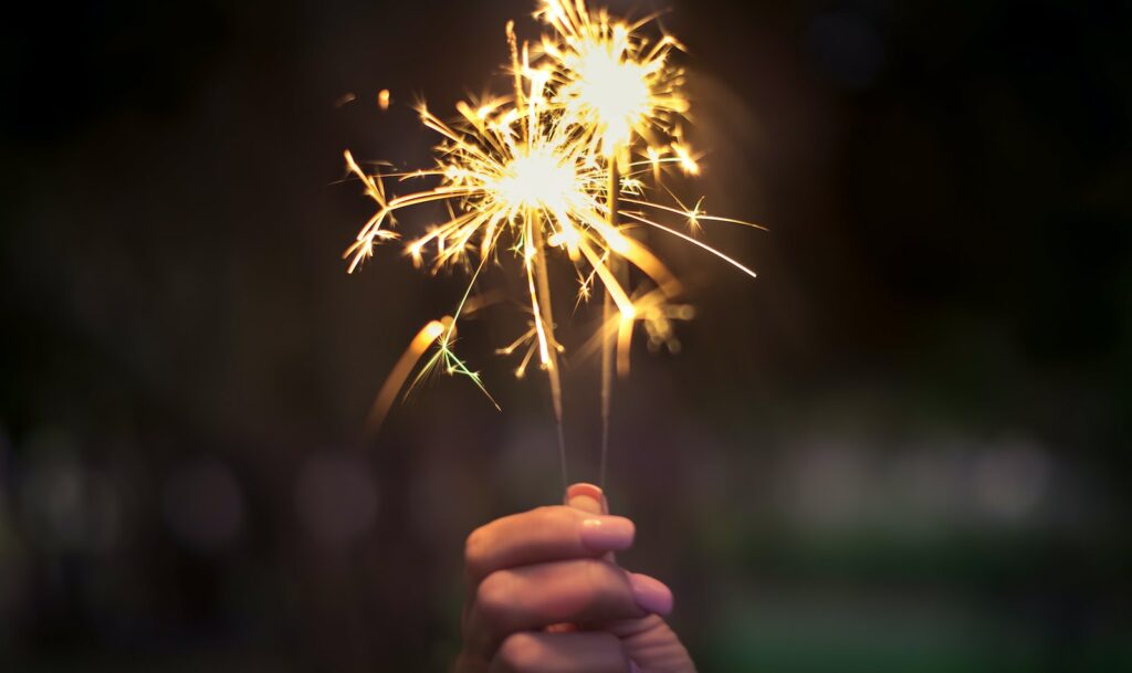 Person Holding Lighted Sparkler