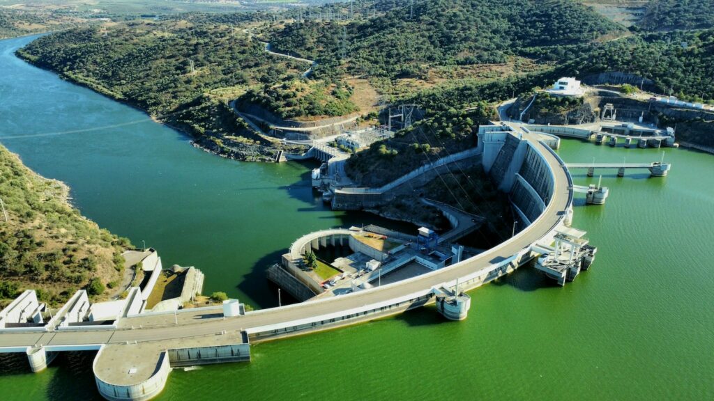 an aerial view of a dam in the middle of a lake