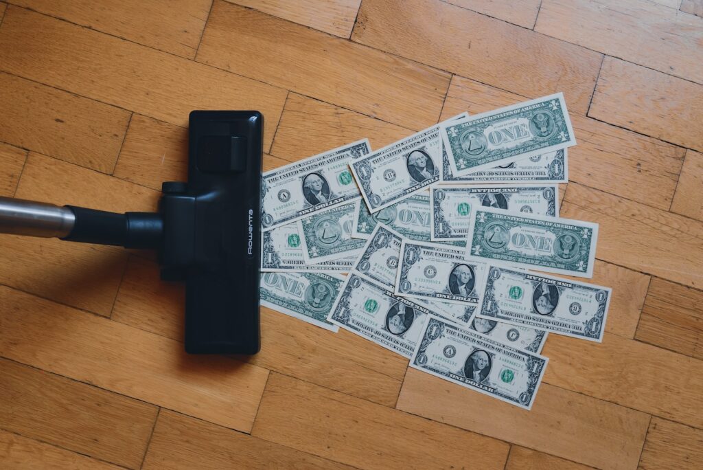 a pile of money sitting on top of a wooden floor