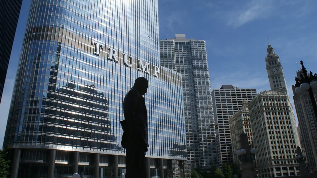 Silhouette of Statue Near Trump Building at Daytime