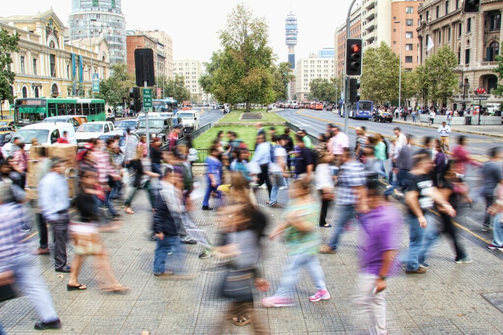 timelapse photo of people passing the street