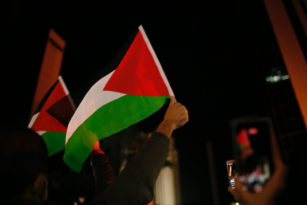 person holding green white and red flag