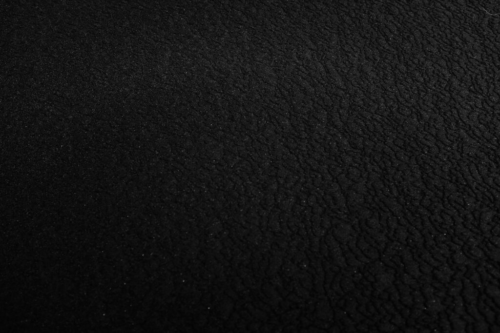 a black and white photo of a black surface