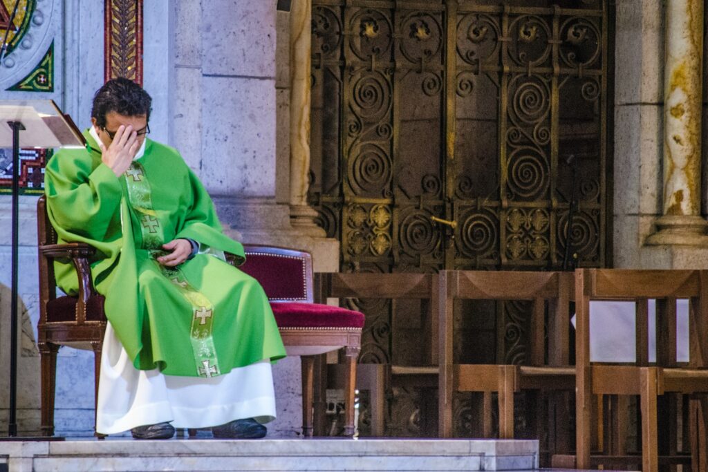 man in green robe sitting on chair