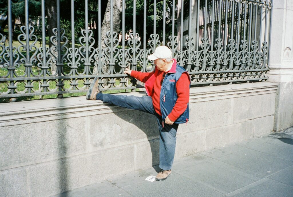 woman in blue jacket and blue denim jeans standing on gray concrete floor during daytime