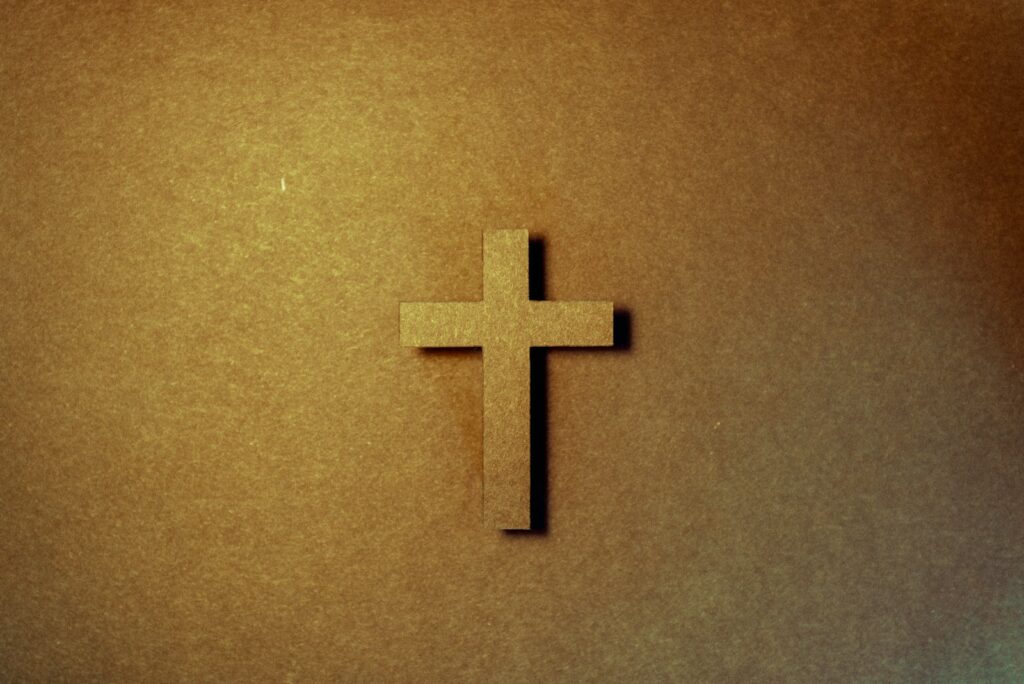 brown cross on brown surface