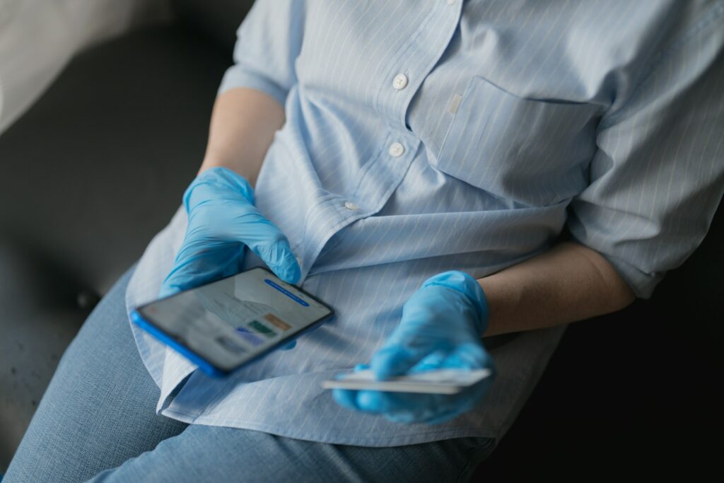 person in blue button up shirt and blue denim jeans sitting on gray couch