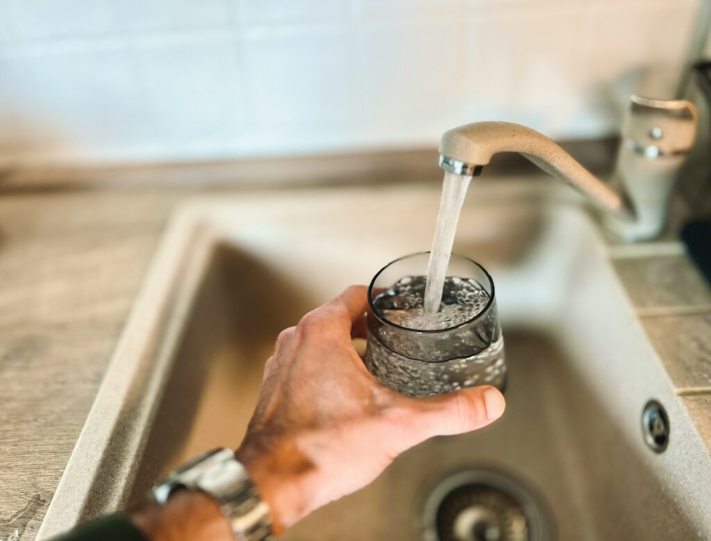 a hand holding a glass of water