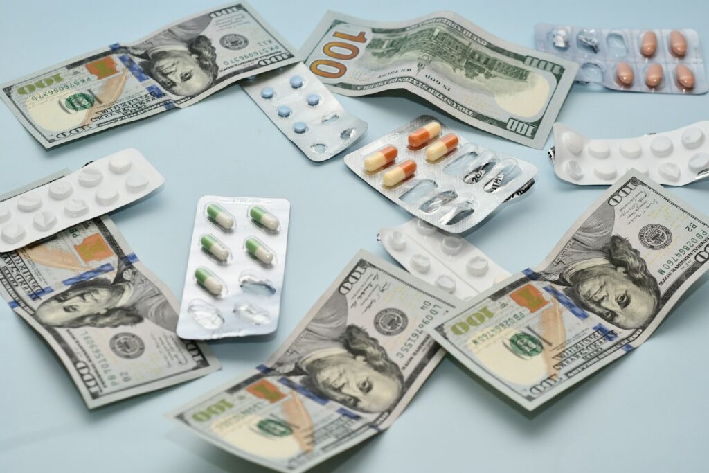 a pile of pills and money sitting on top of a table