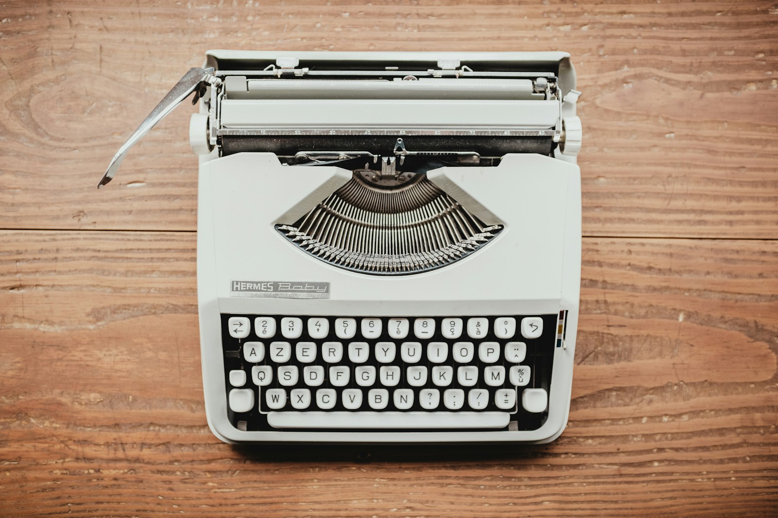 white and black typewriter on table